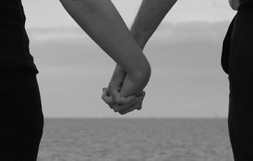 Black and white image of couples holding hands